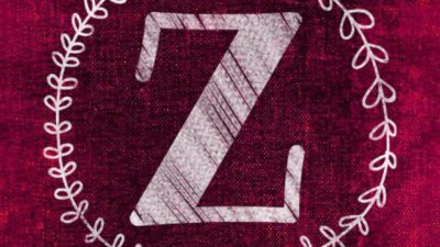 En röd bakgrund med ett vitt stort Z i mitten. Runt bokstaven är en ritad kvist med blad.